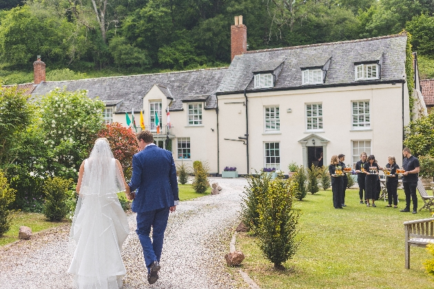 Couple walking towards Combe House Hotel