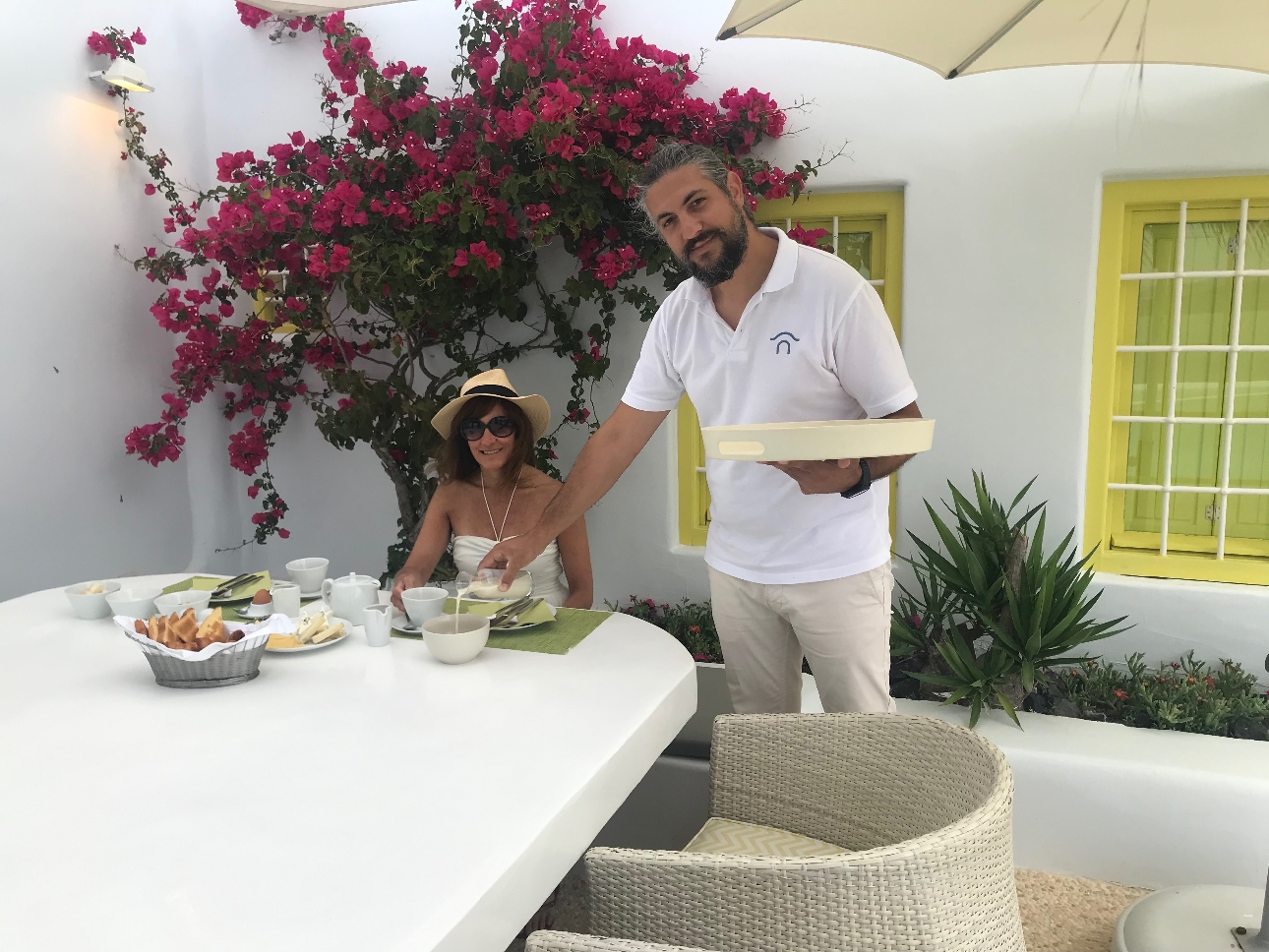 editor claire sat at outside table having breakfast served by waiter