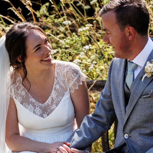 bride and groom holding hands and smiling giving the gift of heal rewilding