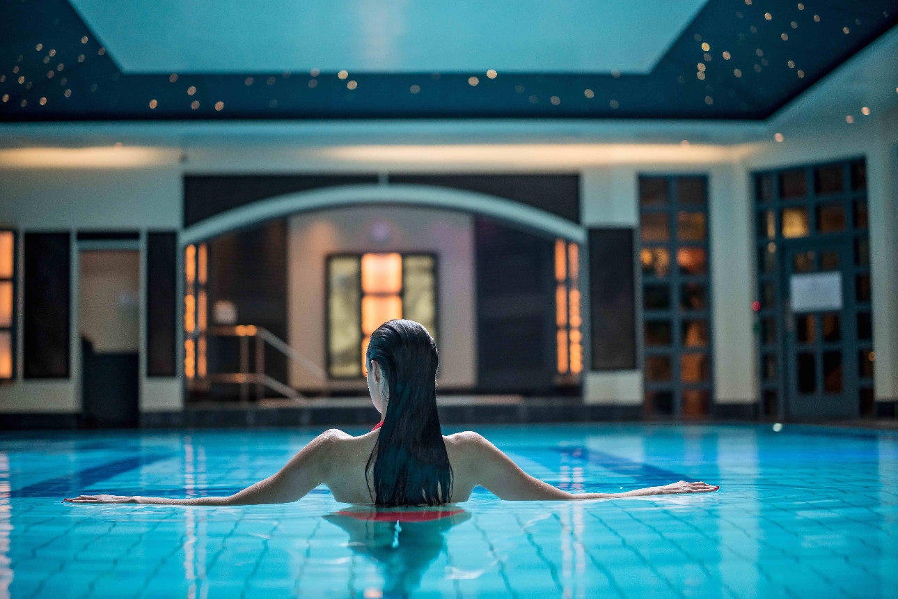 image of woman walking through a spa pool