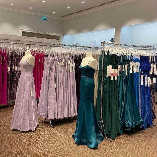 different coloured bridesmaid dresses on shop floor