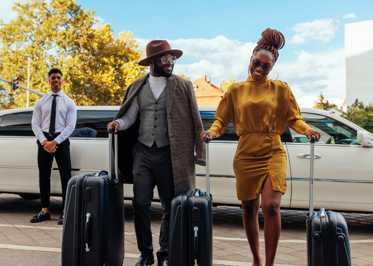 couple with luggage getting out of car