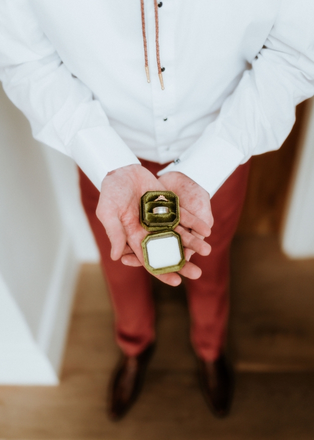 Groom holding wedding rings made at Silver and Steel Studios