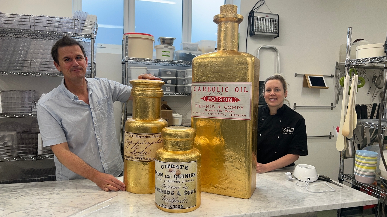 Luke Jerram with chocolate bottles made for Edible History exhibition