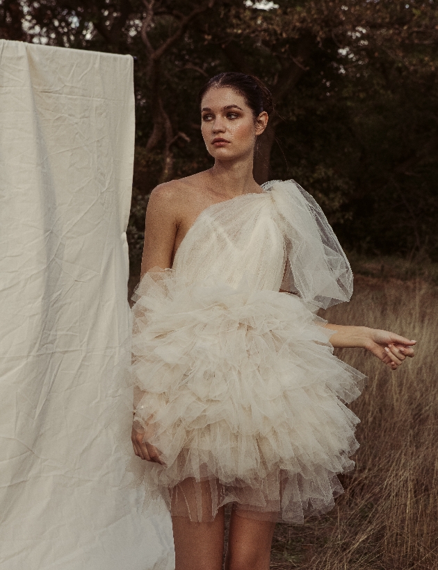 model in short tutu layered skirt one shoulder dress