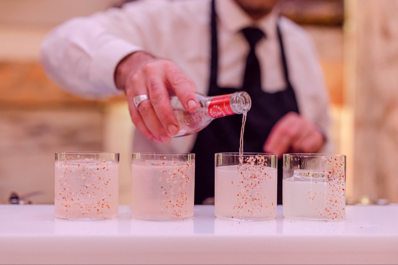 bartender serving drinks in glasses