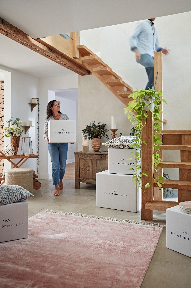 couple unpack gifts from boxes in their home