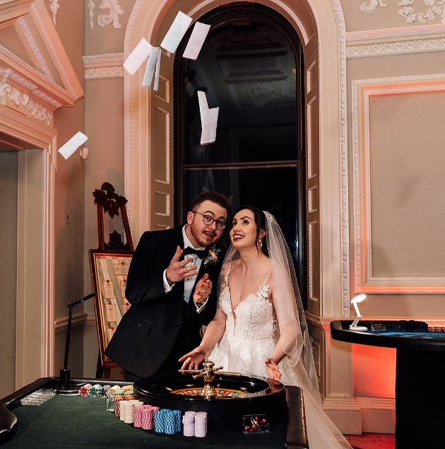 Bride and groom celebrate at the roulette table