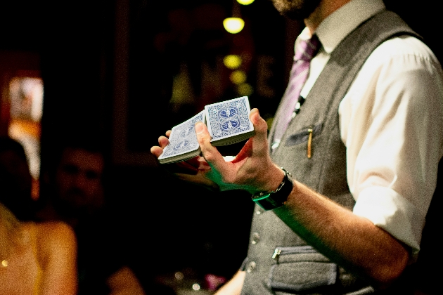 Close up on magician's hands performing a card trick