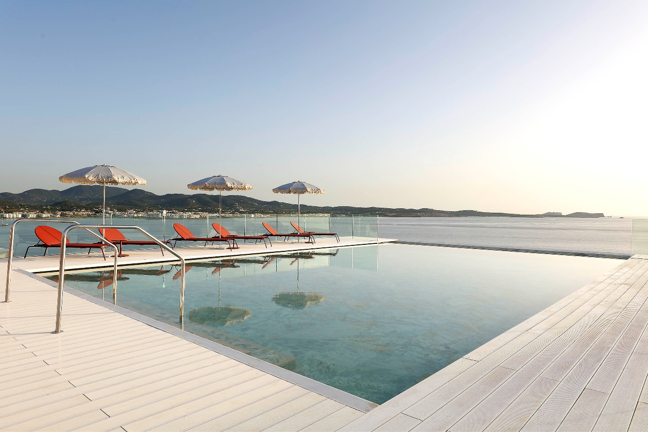 square pool on terrace with sea views