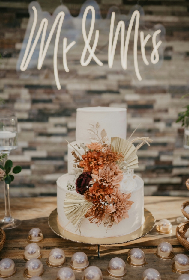 wedding cake with brown flowers on it